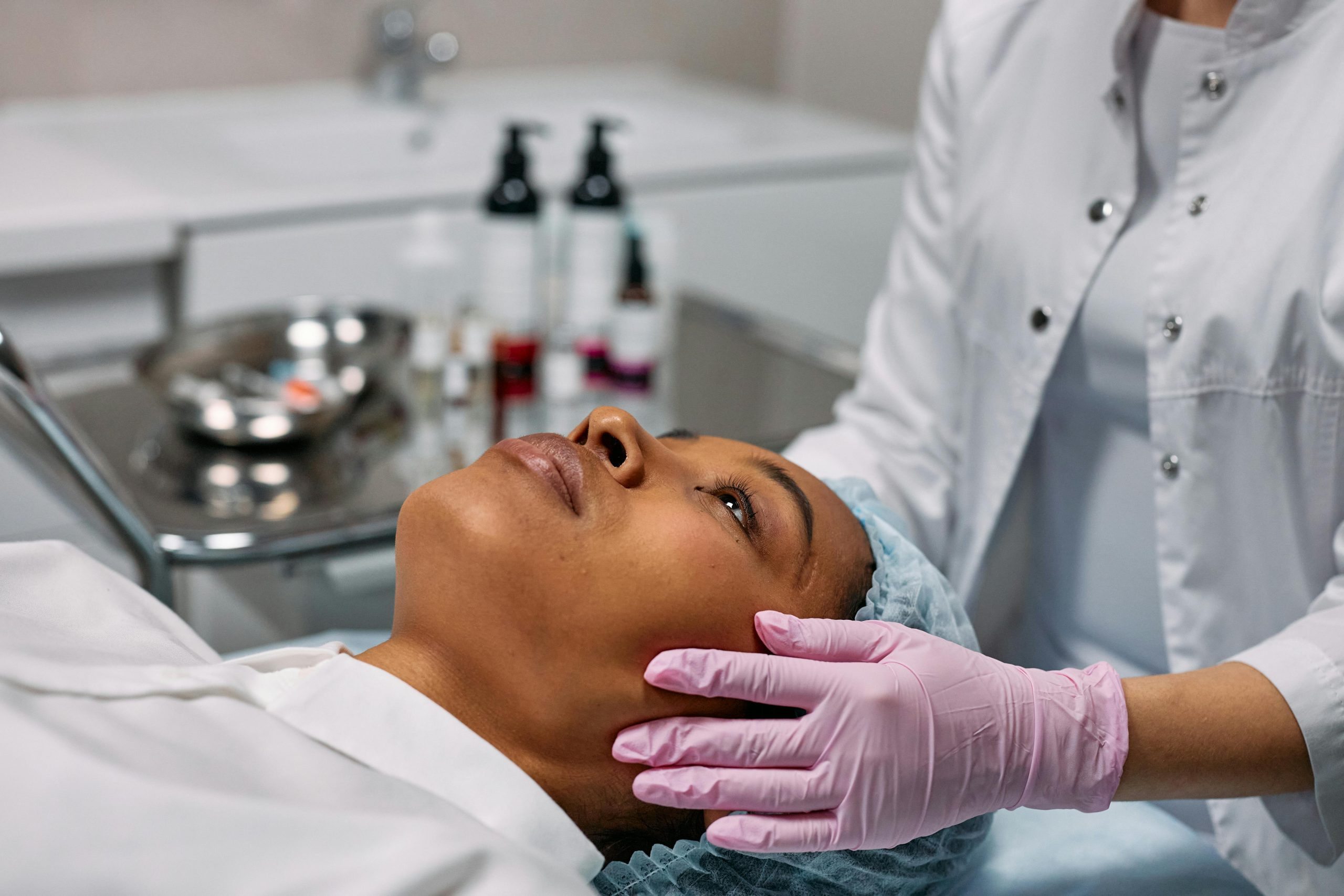 patient lying on a clinic bed, appearing relaxed and ready for a cosmetic procedure