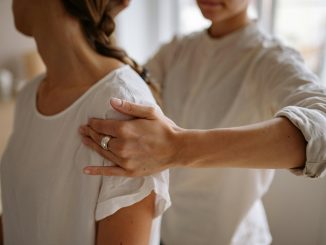 medical practitioner applying pressure to a patient's arm